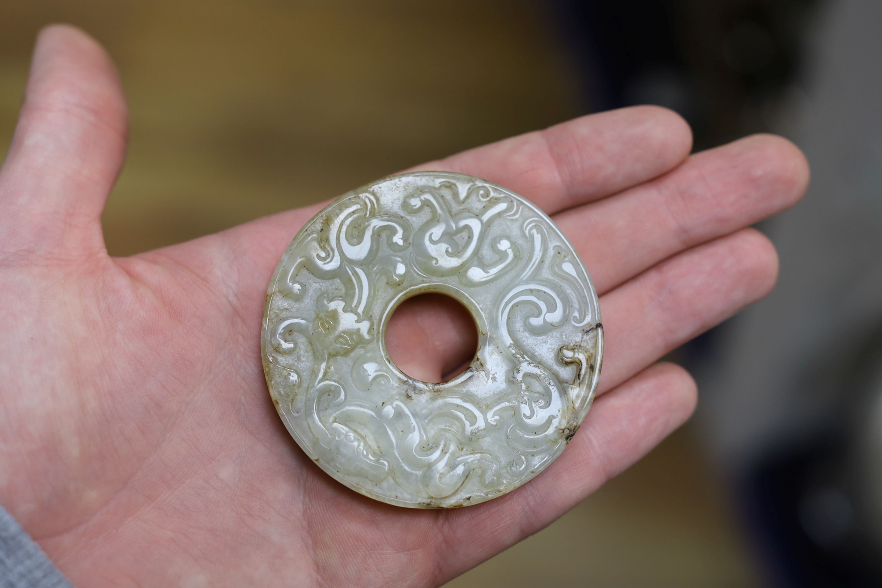 A Chinese white and brown jade bi disc, a Japanese bronze mount and a Chinese archaistic bronze vessel